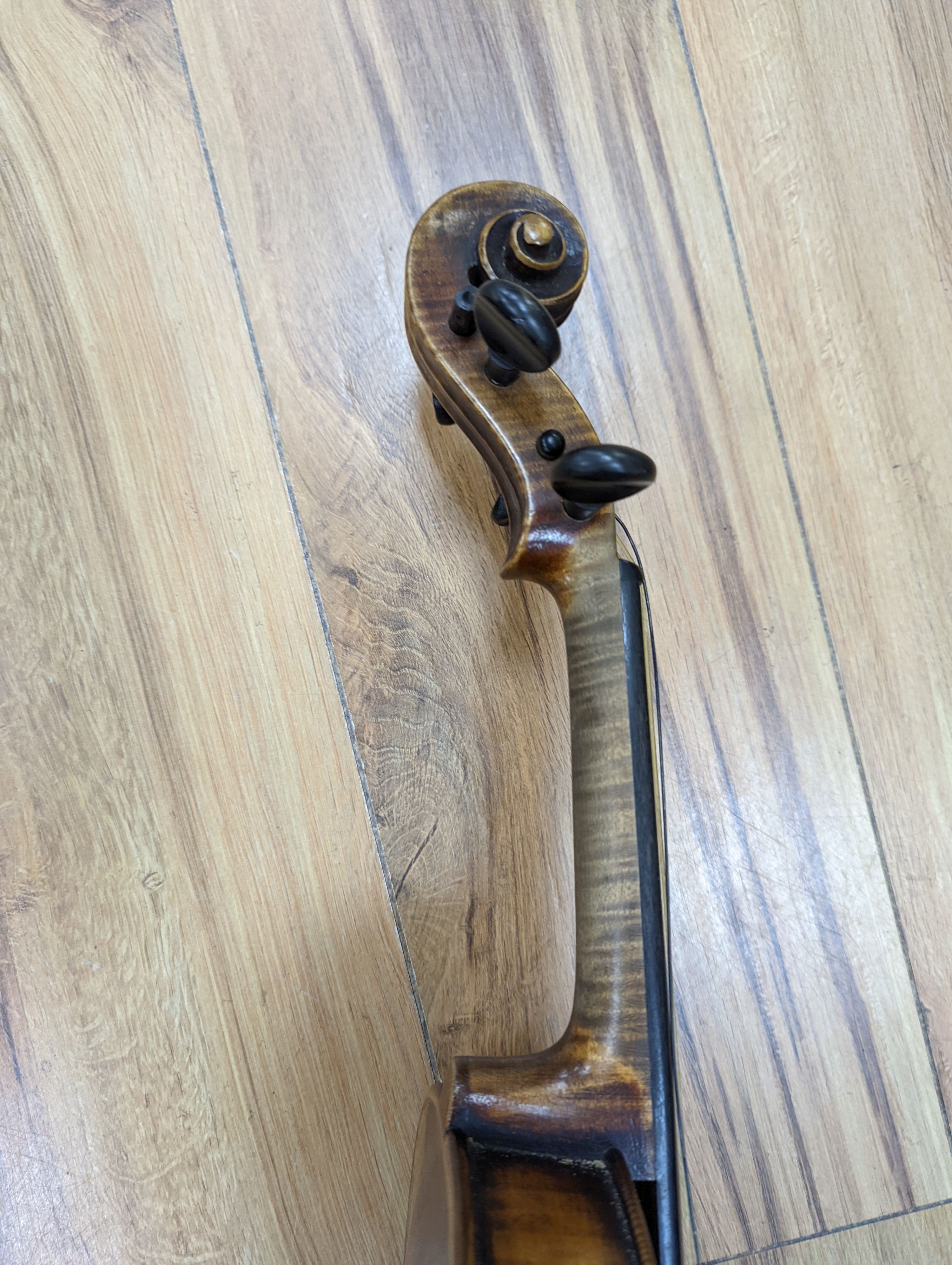 A late 19th century German violin, case, 60 cms long.